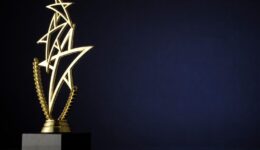 Stylish trophy with three gold stars and wreath