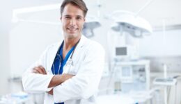 Hes very professional and great at what he does. Close-up of a confident male doctor standing with his arms crossed in the hospital.