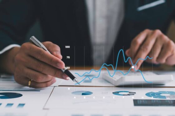 Business professional analysing reports with data lineage solutions and data flow visualisation on digital charts.