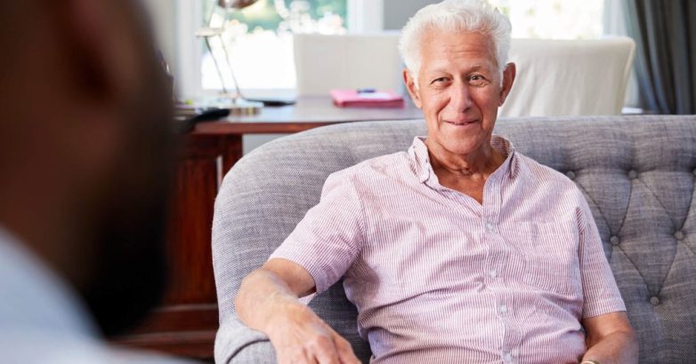 Happy senior man taking financial advice at home