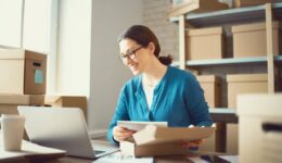 Woman is working at warehouse for online store.