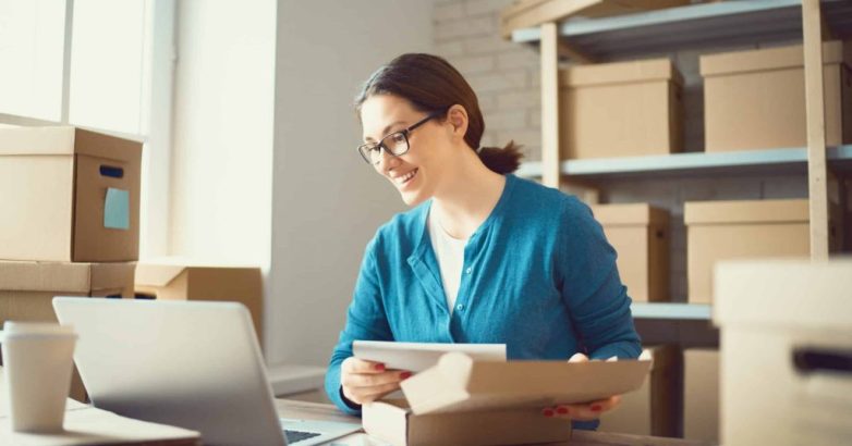 Woman is working at warehouse for online store.
