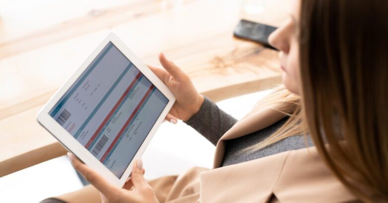 Young elegant businesswoman looking through online financial information Young elegant businesswoman looking through online financial information