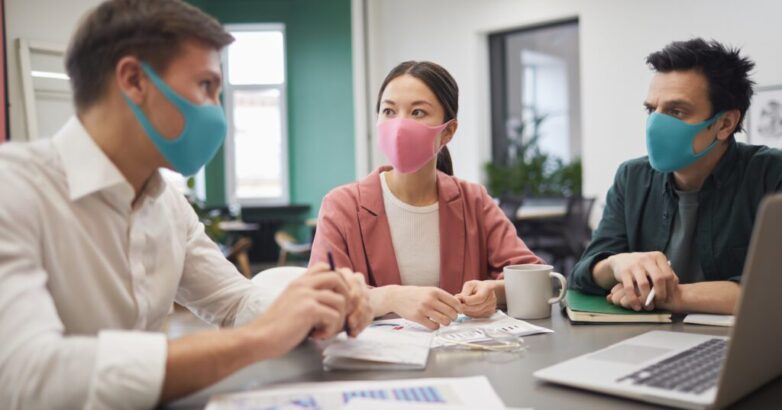 Business people in protective masks Business people in protective masks