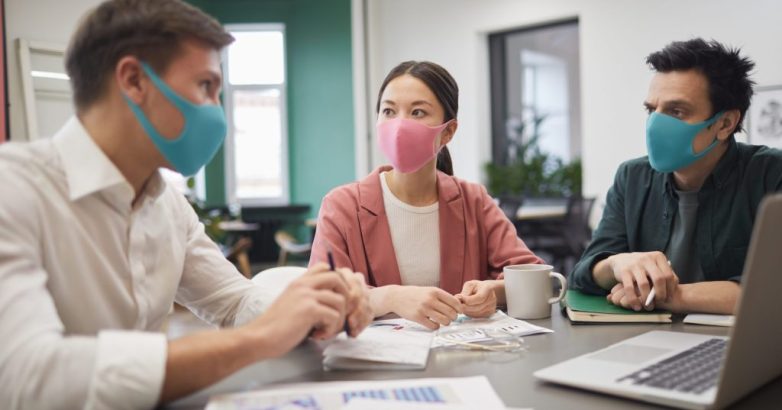 Business people in protective masks
