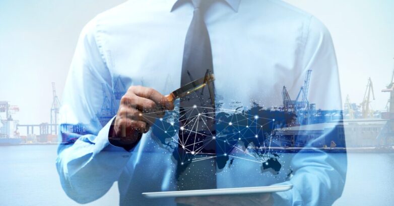 Businessman holding tablet and magnifier