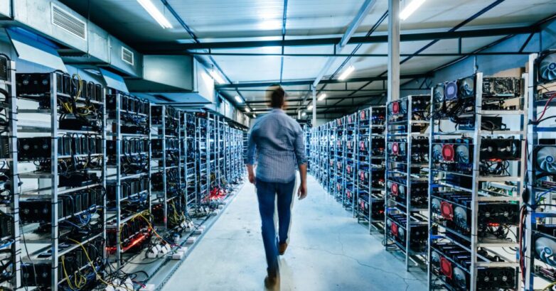IT business owner walking in high tech data center full of servers and computers. IT business owner walking in high tech data center full of servers and computers.