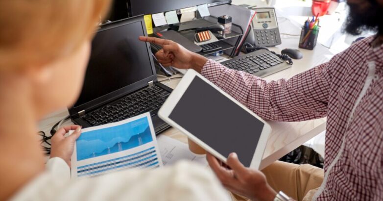 business team with laptop, chart and tablet pc business team with laptop, chart and tablet pc