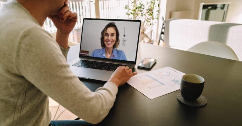 Woman teleconferencing with female colleague on laptop Woman teleconferencing with female colleague on laptop