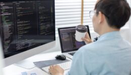 Professional development programmers are sipping coffee in a private office, Working on coding or programming on a computer, Write information or code for the website, HTML, Javascript, Software.