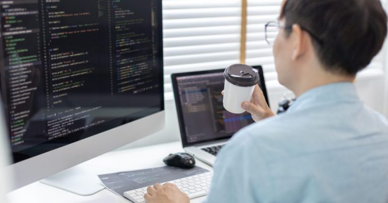 Professional development programmers are sipping coffee in a private office, Working on coding or programming on a computer, Write information or code for the website, HTML, Javascript, Software.