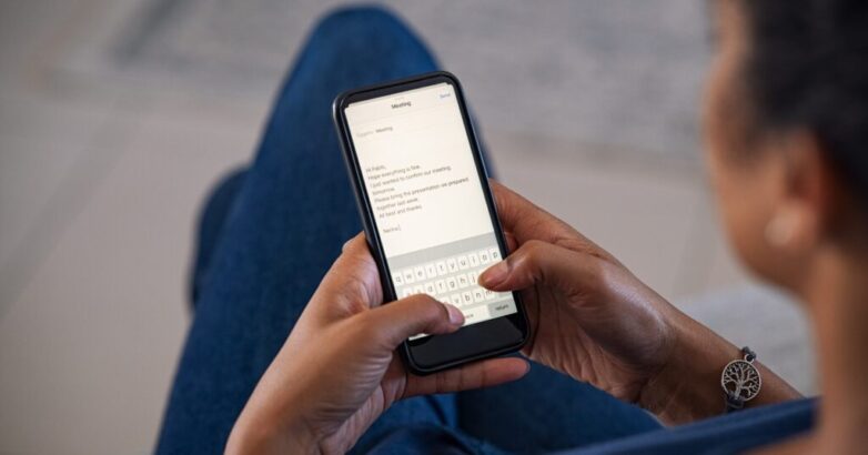 Woman typing email on smartphone Woman typing email on smartphone