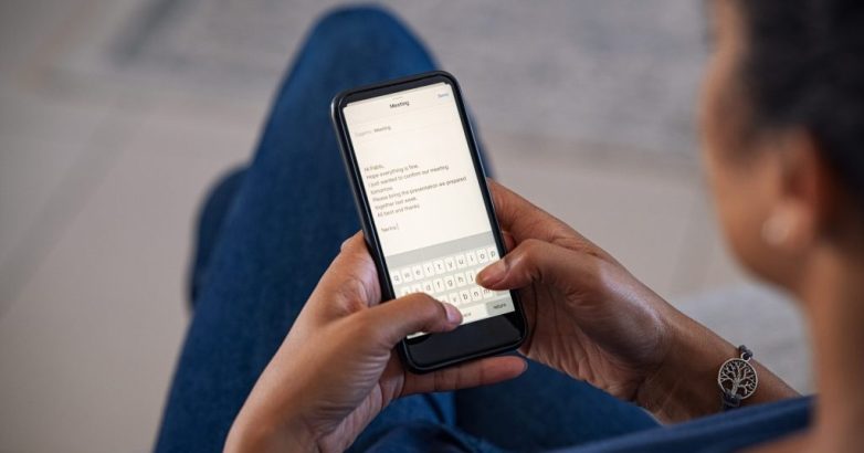Woman typing email on smartphone