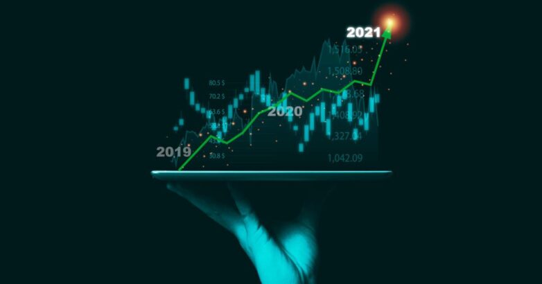 Stock market investment concept, businessman hand holding tablet and showing technical investment chart graph.