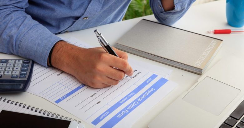 Man preparing an Insurance Claim Form