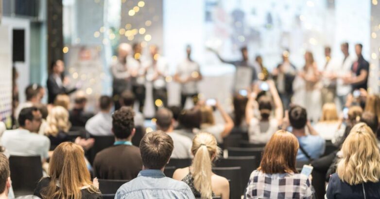 Young business team receiving award at best business project competition event.