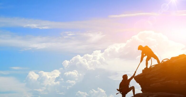 Climbing team are on the climb to the cliff,hiking and team work concept.