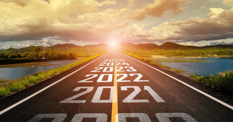 2020-2025 written on highway road in the middle of empty asphalt road and beautiful blue sky. Concept for vision 2021-2025.