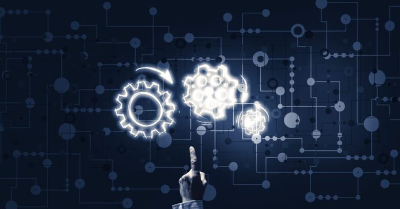 Glowing cogwheel mechanism icon on dark background as symbol of teamwork