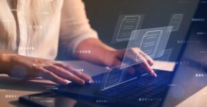 Businesswoman working on laptop with virtual screen. Process automation to efficiently manage files. Online documentation database and document management system concept. Businesswoman working on laptop with virtual screen. Process automation to efficiently manage files. Online documentation database and document management system concept.