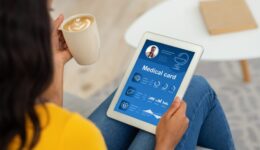 Black lady checking her medical card online, using pad