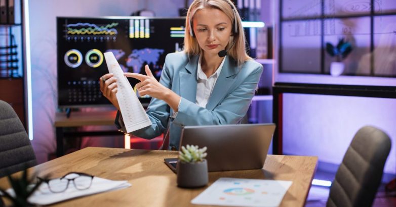 Business woman using headset and laptop for video call