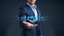 Close-up of businessman presenting digital handshake with glowing blue light trails deal agreement