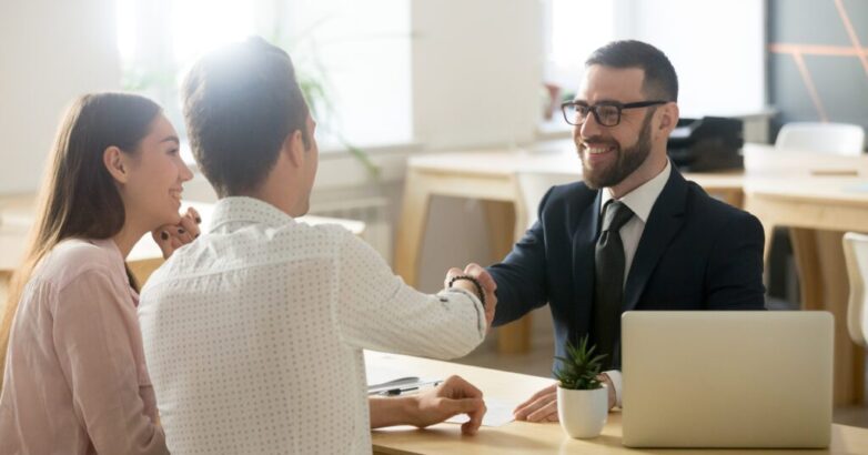 Smiling lawyer or financial advisor handshaking senior couple at Smiling lawyer or financial advisor handshaking senior couple at