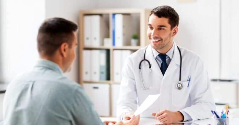 doctor giving prescription to patient at hospital