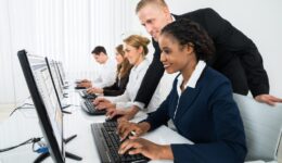 Manager Assisting His Staff In Office