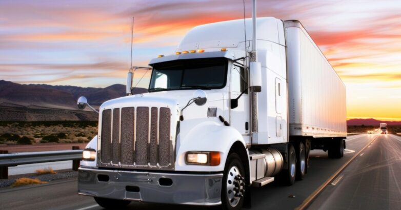 Trucking Truck Driver. White Cargo Truck on the Highway at Sunrise
