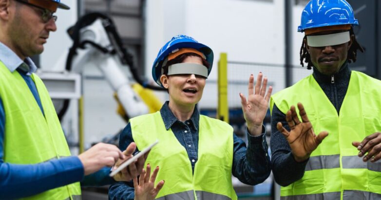 Team of engineers having simulation experience with futuristic virtual reality glasses inside robotic factory - Tech industry and metaverse concept Industrial metaverse in manufacturing with AR, VR, and digital twin technology transforming factory automation and smart industry operations.