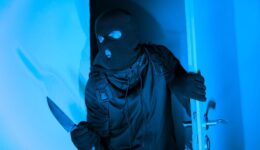 Burglar with knife entering through apartment door