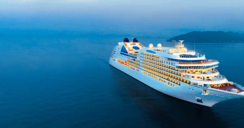 Aerial view of beautiful white cruise ship above luxury cruise i