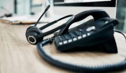 Telephone, contact us with call center, communication and headphone with microphone on work desk. Contact center, customer support and phone, consulting and customer service with callcenter voip.