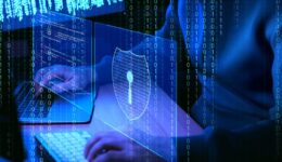 Cyber attack. Hacker working with computers in dark room, closeup. Binary code and virtual screens near him