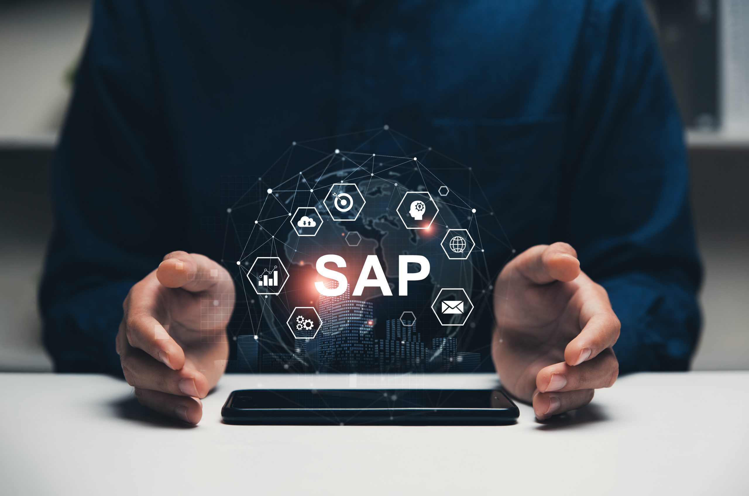 Hands of CEO is on the table with smartphone at the center, Hologram of SAP, System Application products for ERP, Enterprise Resource Planning, business and technology concept.